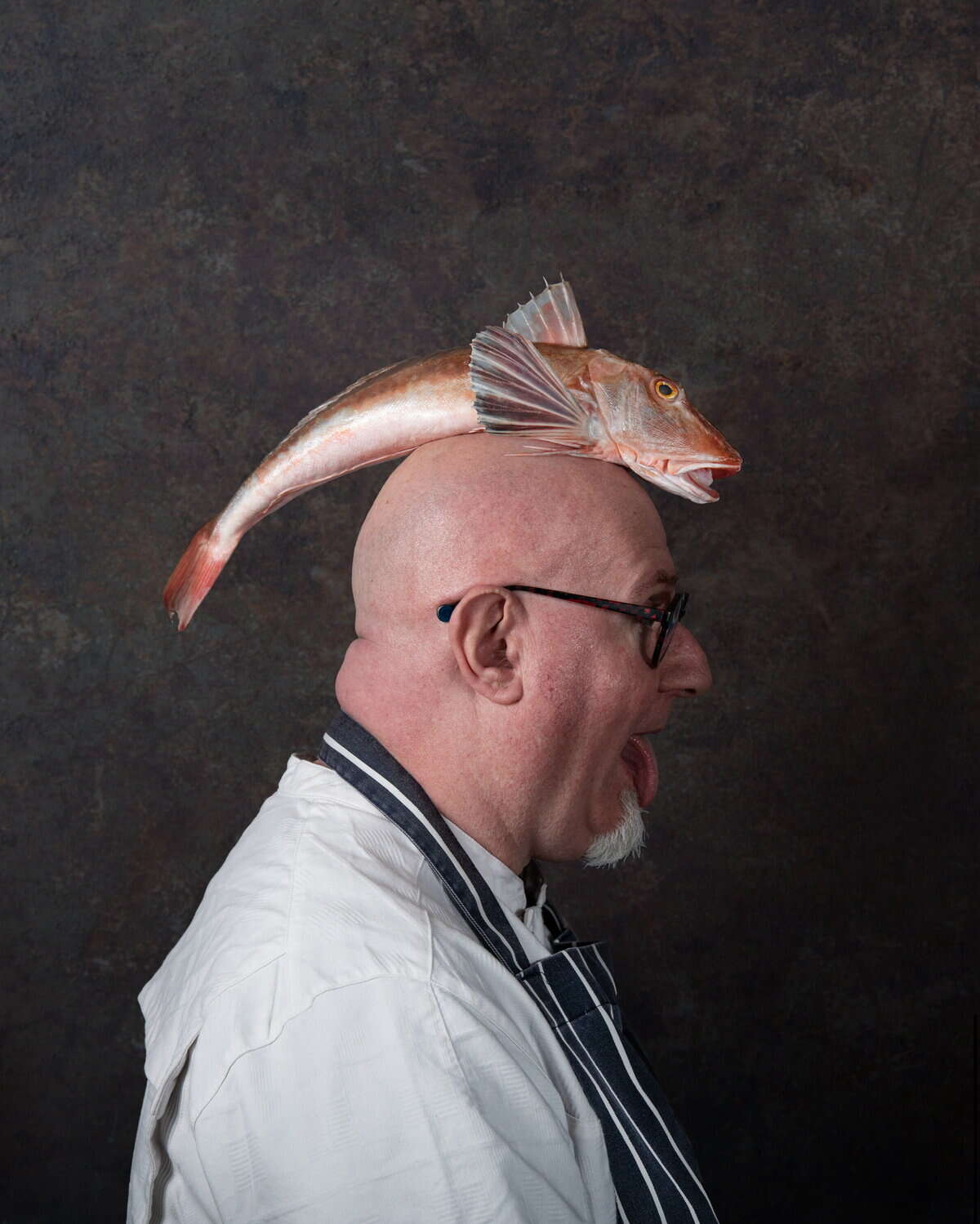 Chef Fish Man with fish on head, funny pose.